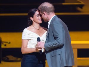 Prince Harry and Meghan Markle share a kiss onstage at the Invictus Games