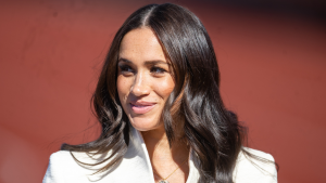 Meghan Markle just stepped out in a white mini dress and a bold red lip